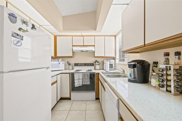 kitchen with light countertops, white appliances, a sink, and under cabinet range hood