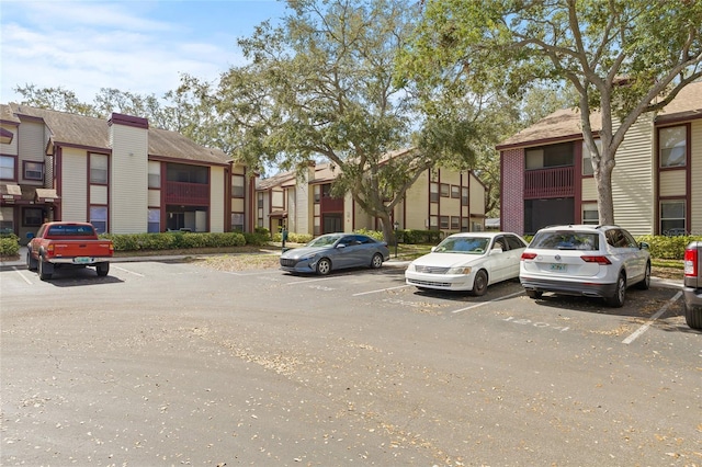 uncovered parking lot with a residential view