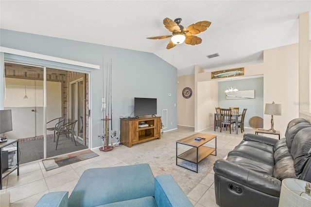 living room with lofted ceiling, tile patterned flooring, visible vents, and ceiling fan with notable chandelier