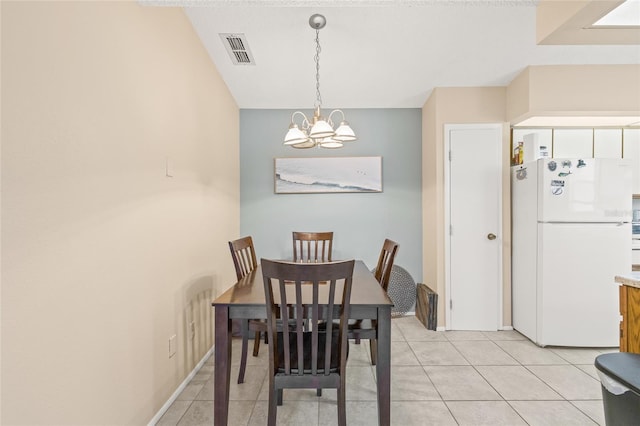 dining area with a chandelier, visible vents, baseboards, and light tile patterned floors