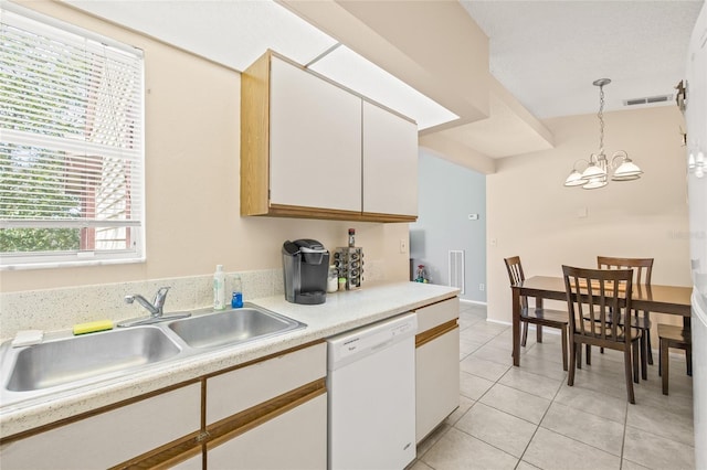 kitchen featuring light tile patterned floors, light countertops, white cabinetry, white dishwasher, and a sink