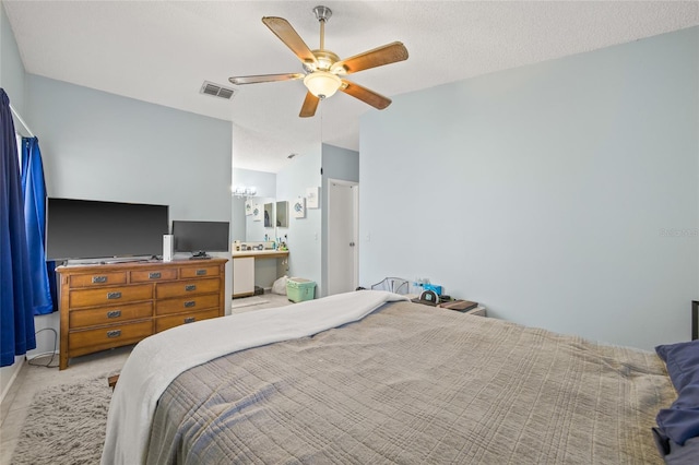 carpeted bedroom featuring lofted ceiling, visible vents, a ceiling fan, a textured ceiling, and ensuite bath