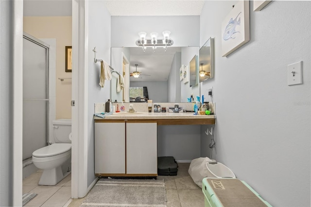 full bathroom featuring toilet, ceiling fan, vanity, a shower stall, and tile patterned floors