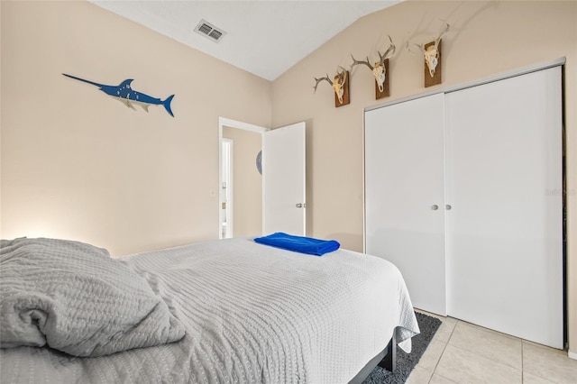 bedroom with light tile patterned floors, a closet, and visible vents