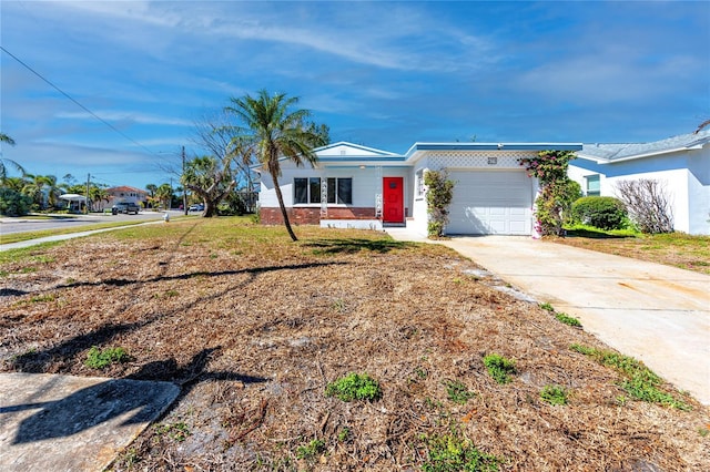 ranch-style house featuring driveway, a front lawn, and an attached garage