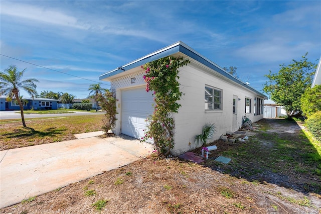 view of side of property with concrete driveway