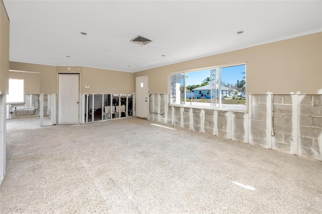 living room featuring ornamental molding and visible vents