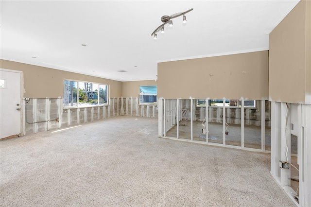 unfurnished room featuring ornamental molding and rail lighting