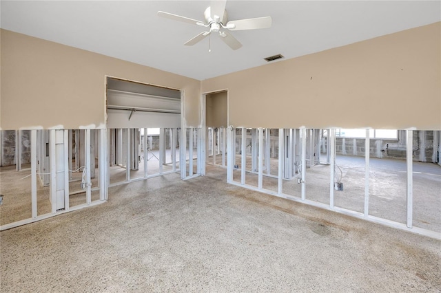 unfurnished room featuring ceiling fan, a wealth of natural light, and visible vents