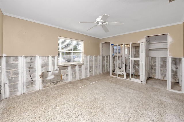 unfurnished bedroom featuring a ceiling fan, crown molding, and two closets