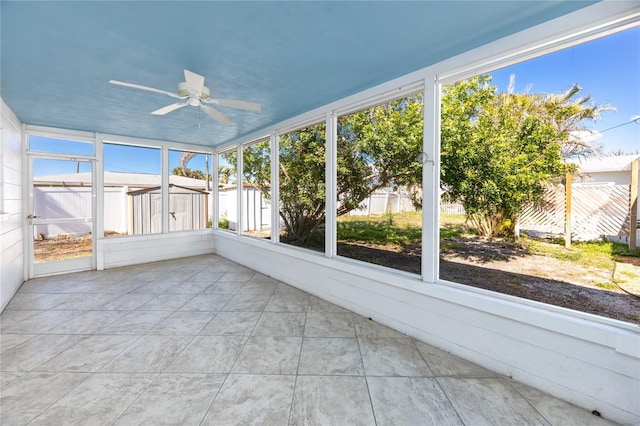 unfurnished sunroom with a ceiling fan