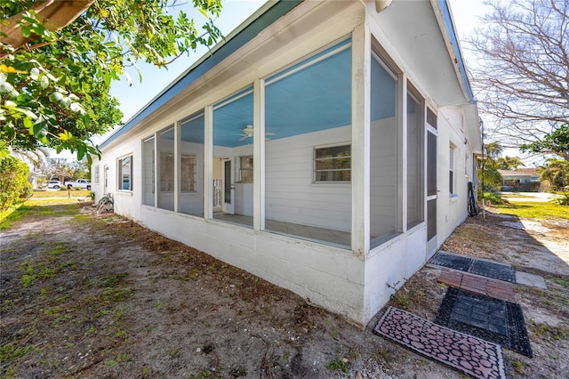 view of side of home featuring a sunroom