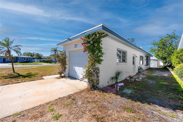 479 80th Way, St Pete Beach, FL 33706 - view of side of property featuring driveway and an attached garage