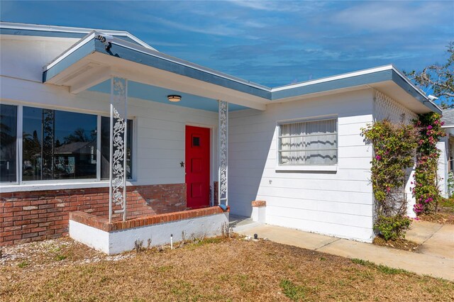 479 80th Way, St Pete Beach, FL 33706 - view of front of property with brick siding and covered porch