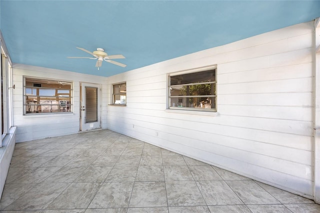479 80th Way, St Pete Beach, FL 33706 - empty room with a ceiling fan and wood walls