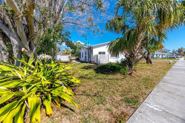 479 80th Way, St Pete Beach, FL 33706 - view of side of home featuring a lawn