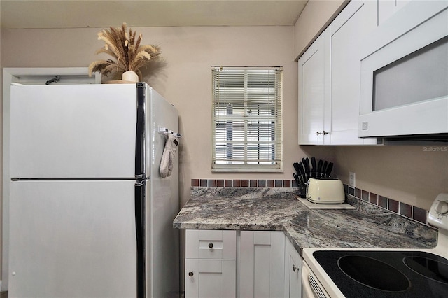 kitchen featuring white appliances and white cabinets