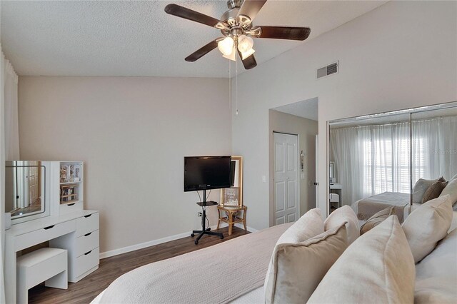 bedroom featuring baseboards, visible vents, lofted ceiling, ceiling fan, and wood finished floors