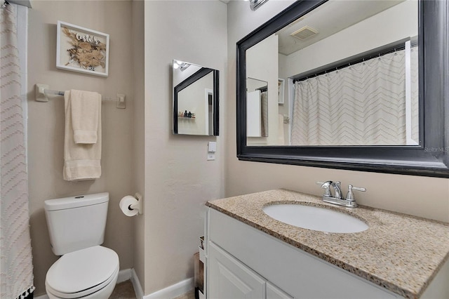 full bathroom featuring toilet, vanity, visible vents, and baseboards