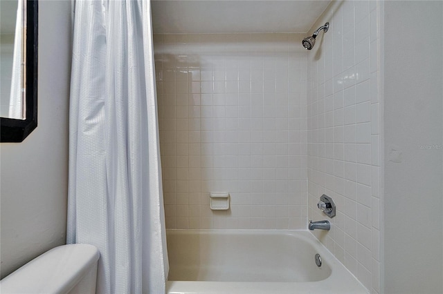 full bathroom featuring shower / bath combo and toilet