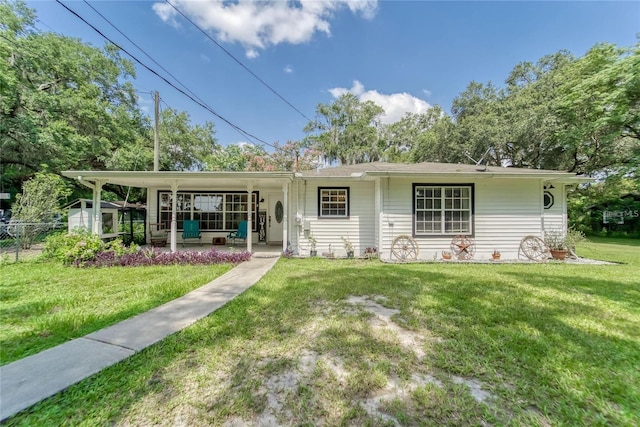 ranch-style house with a porch, a front yard, and fence