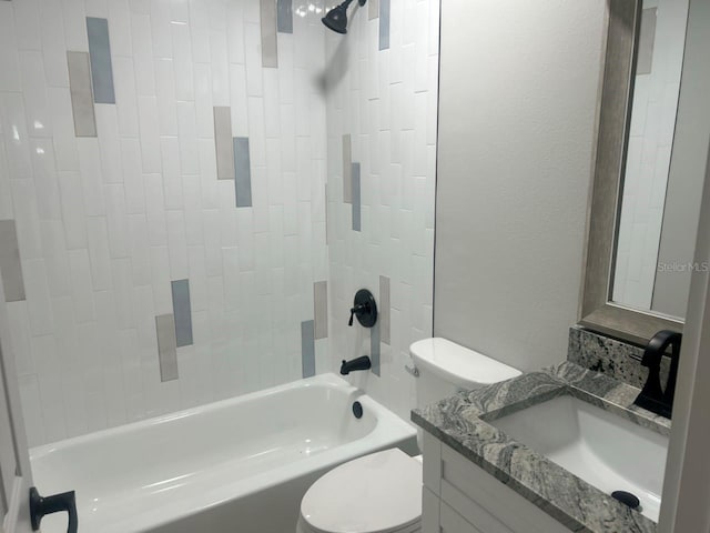 full bathroom with vanity, toilet, shower / bath combination, and a textured wall