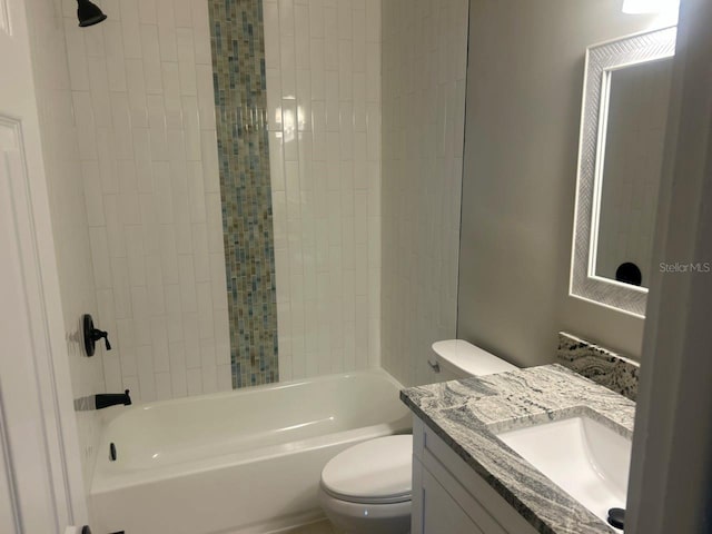 bathroom featuring vanity, toilet, and  shower combination