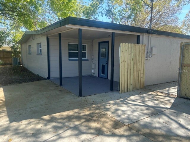 exterior space with cooling unit and fence