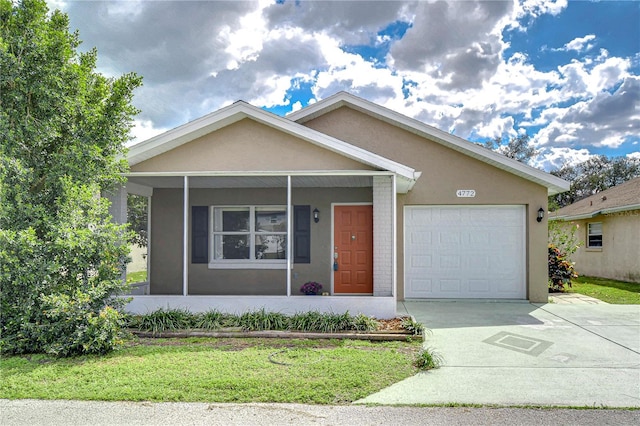 view of front facade featuring a garage, stucco siding, concrete driveway, and brick siding