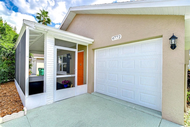 garage featuring concrete driveway