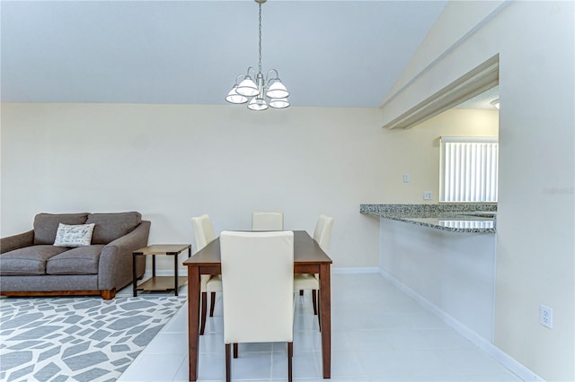 dining space featuring lofted ceiling, baseboards, and an inviting chandelier