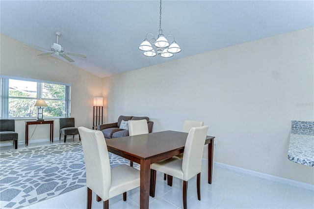 dining room with lofted ceiling, light tile patterned floors, baseboards, and ceiling fan with notable chandelier