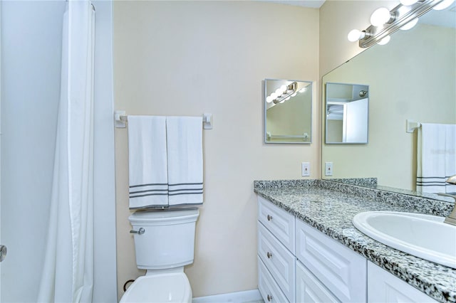 bathroom featuring toilet and vanity