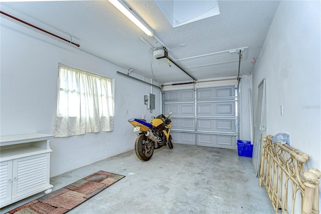 garage featuring concrete block wall and a garage door opener