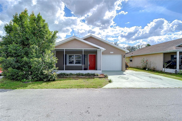 view of front of home with driveway, a garage, a front yard, and stucco siding