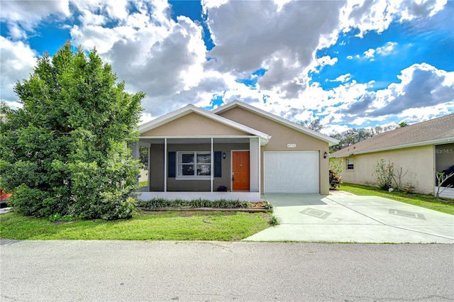 single story home with a garage, driveway, a front yard, and stucco siding