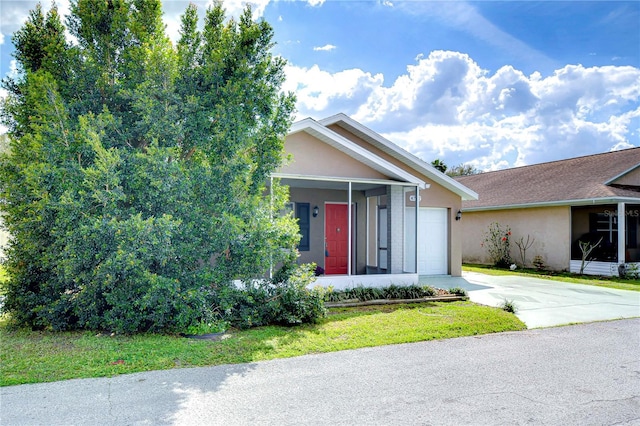 view of front of home featuring a garage, concrete driveway, and stucco siding