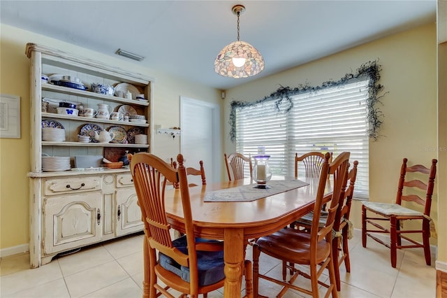 dining space with visible vents, baseboards, and light tile patterned floors