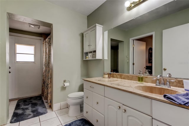 bathroom with baseboards, toilet, a shower with curtain, tile patterned floors, and vanity