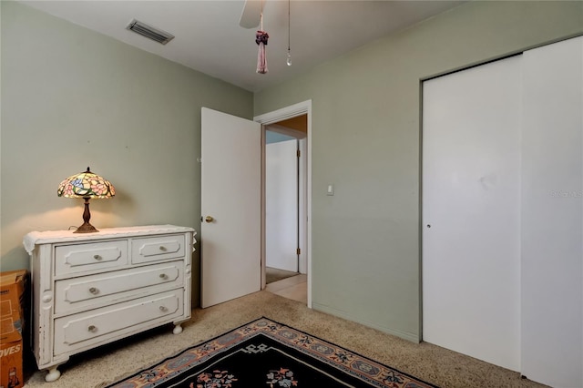 bedroom featuring a ceiling fan, light colored carpet, a closet, and visible vents