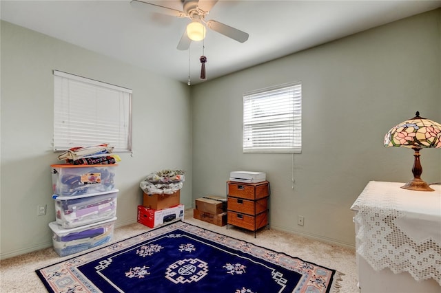 playroom featuring carpet floors, baseboards, and a ceiling fan