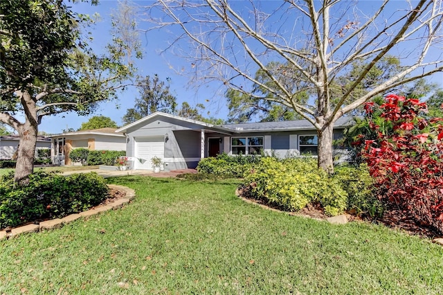 ranch-style home with a garage and a front yard