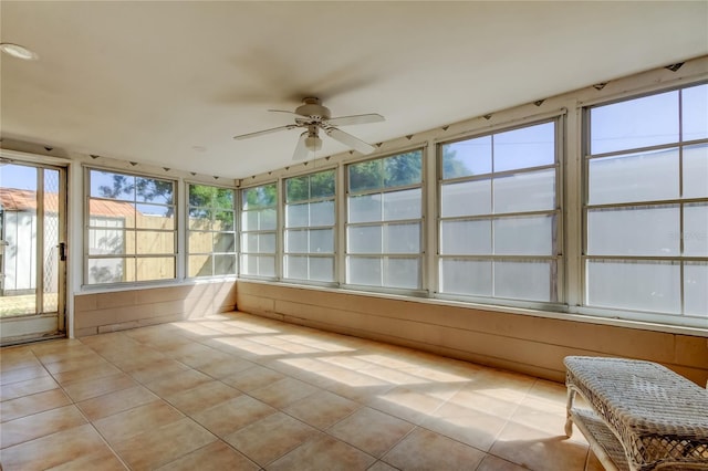 unfurnished sunroom with ceiling fan and a healthy amount of sunlight