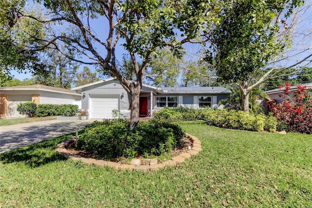 single story home featuring an attached garage, concrete driveway, and a front yard