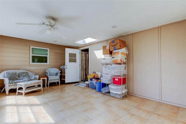 interior space featuring a skylight and ceiling fan