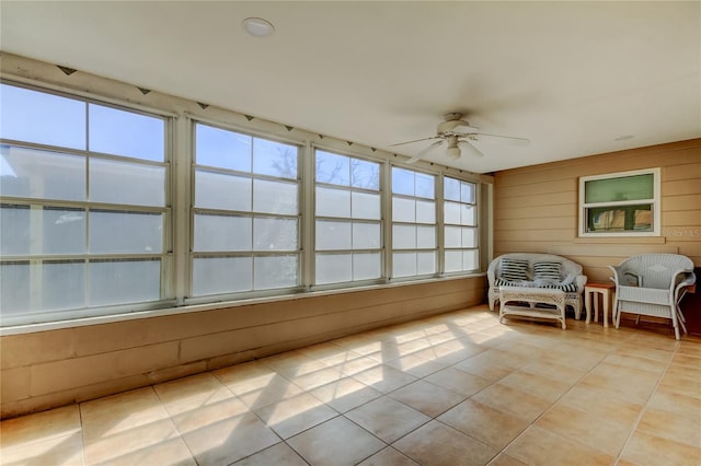 unfurnished sunroom with ceiling fan