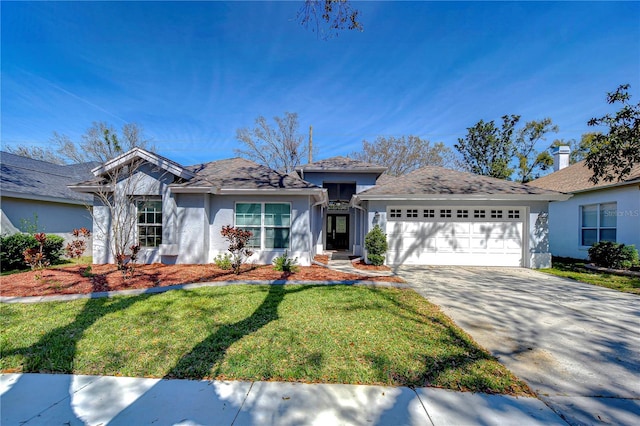 ranch-style home featuring a garage, concrete driveway, a front yard, and stucco siding