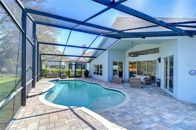 pool featuring glass enclosure, a patio area, and an outdoor living space