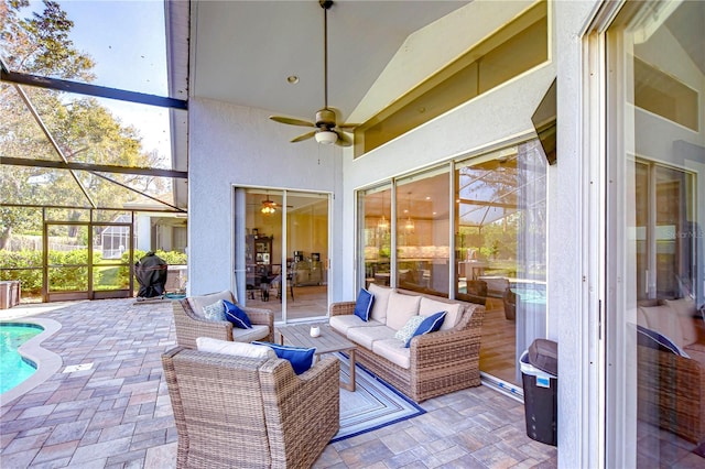 view of patio / terrace featuring an outdoor pool, a lanai, ceiling fan, and an outdoor living space