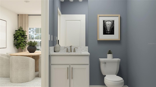 bathroom featuring toilet and vanity